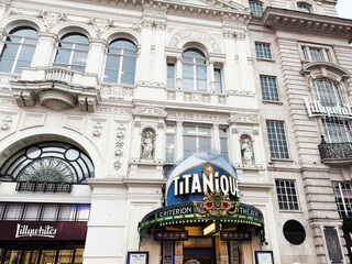 Naklejka premium Titanique marquee and ornate theatre facade at the Criterion Theatre in London UK on a bustling West End street