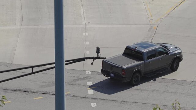 Aerial view of flock surveillance camera cameras mounted above traffic light and road intersection in Columbus, Ohio surveying vehicles, cars, and speed limits of passing by passengers license plates