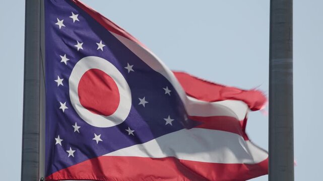 The Burgee flag of Ohio, a red, white, and blue U.S. flag with a triangular swallowtail shape in slow motion slo mo close up on pole swaying in wind slowly in color 4k