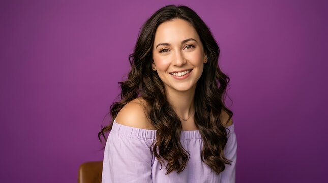 Professional woman smiling warmly in modern purple-toned office setting.