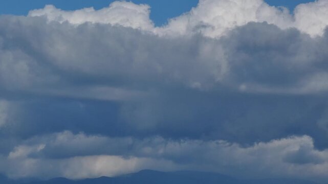 Distant Blue Mountain Ranges and Cumulus Clouds