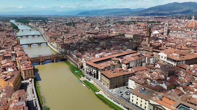 Florence, Italy. Aerial panoramic drone view of the city on a sunny summer day.  Majestic view of the ancient city skyline with basilics, Palazzo Vecchio, bridges, iconic buildings. Europe from above