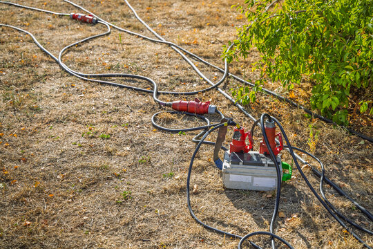 Heavy duty industrial power cables and connectors laid out on a ground