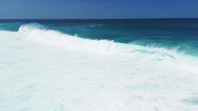 Aerial view of ocean with large storm waves on sunny day