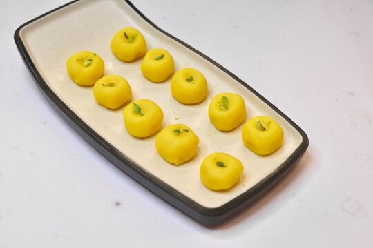 Peda sweet garnished with pista on white plate