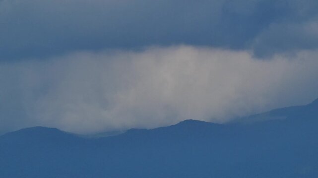 Distant Blue Mountain Ranges and Cumulus Clouds
