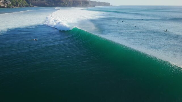 Drone view with breaking ocean waves in ocean on Impossibles beach, Bali