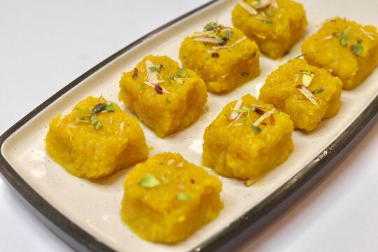 Milk pudding or milk barfi garnished with pista beautifully decorated on white plate