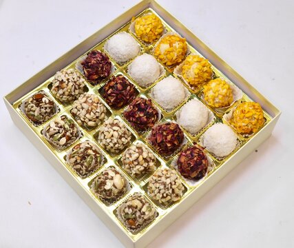 Dry fruit laddu made with almond cashew and pista elegantly placed on a white background 