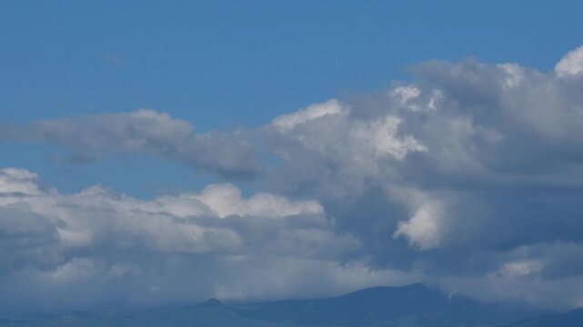 Distant Blue Mountain Ranges and Cumulus Clouds