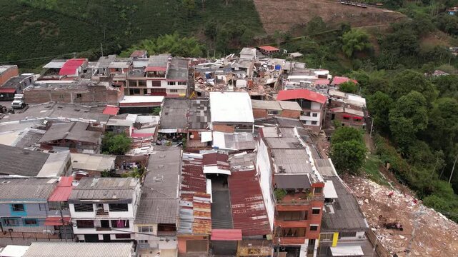 Aerial drone view of severely damaged houses, rubble, and collapsed roofs in the Grisales neighborhood, Quimbaya, Quindio, Colombia, following the August 2026 earthquake