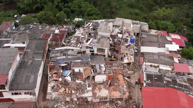 Aerial drone view of severely damaged houses, rubble, and collapsed roofs in the Grisales neighborhood, Quimbaya, Quindio, Colombia, following the August 2026 earthquake