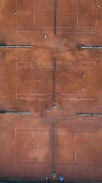Aerial Top-Down View of Clay Tennis Courts with Players During Match