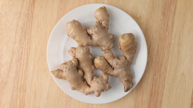 Fresh ginger root rotating on a plate