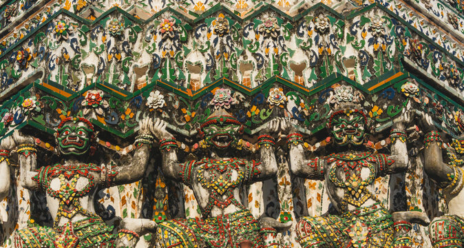 Intricate Giant Yaksha Demon Guardian Sculptures Adorned with Colorful Porcelain Mosaic at Wat Arun Temple in Bangkok Thailand