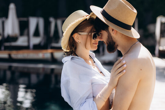 Couple sharing an intimate moment in summer hats