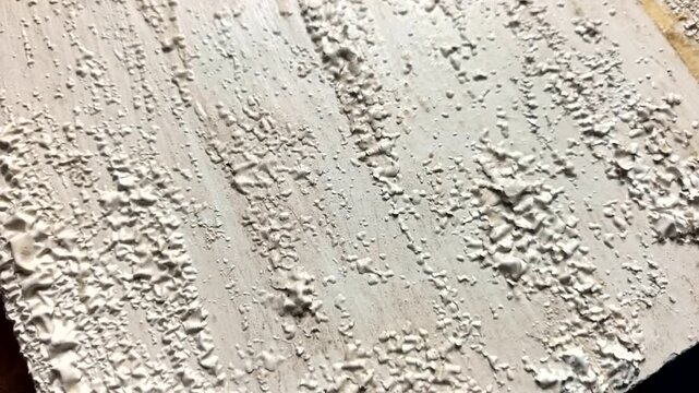 Paint damage timelapse on wood due to chemical reaction. Wood coating deterioration timelapse, white paint blistering and cracking. Time-lapse of white paint peeling and blistering on wooden surface
