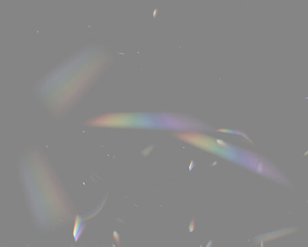 Colorful light refractions appear as scattered shards against a black background. Thin elongated shapes display smooth gradients transitioning through the rainbow spectrum.