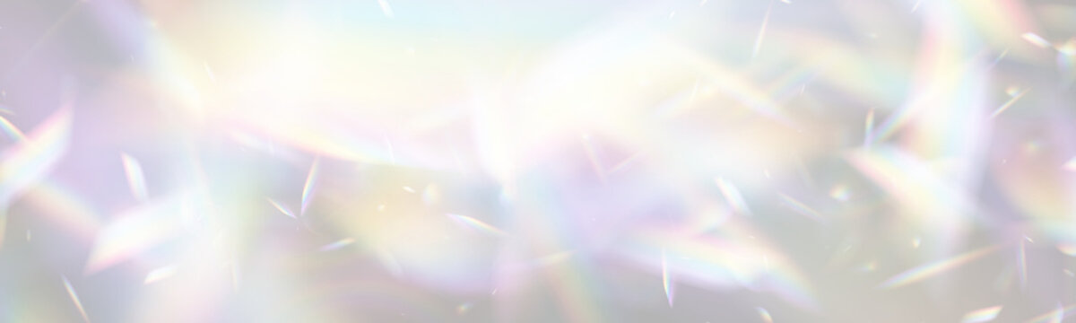 Colorful light diffraction creates vibrant prism effects in this image. Triangular and angular shapes scatter across a soft, glowing background. This visual captures the intricate play of.