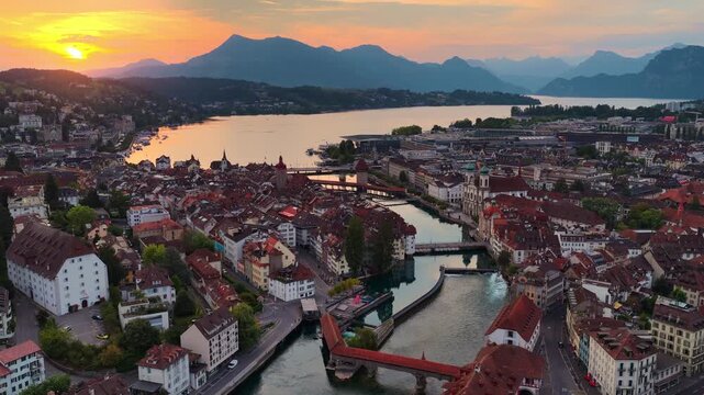 Swiss city of Lucerne aerial view, flying above Lucerne old town at sunrise with lake Lucerne , historic Chapel bridge and Needle dam, tourism in Switzerland