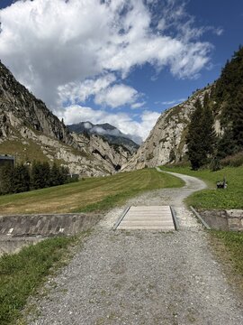 Scenic hiking trail through an alpine mountain valley near Andermatt, Switzerland