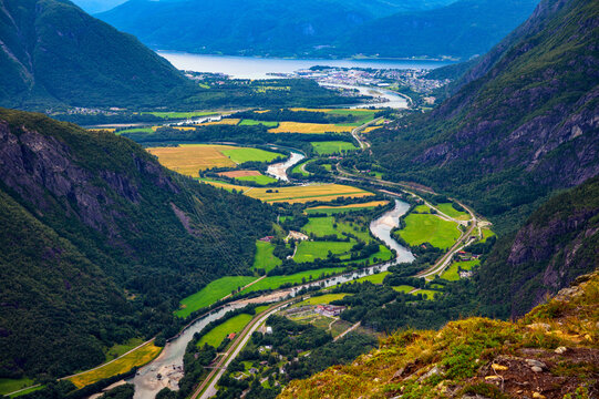 Aerial mountain view over Romsdalen Valley, Rauma River, farms, roads, and Andalsnes near Romsdalsfjord in Norway.