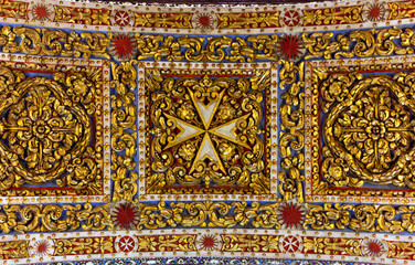 Saint John Co-Cathedral decoration, Valletta, Malta. Ornate gilded ceiling panel featuring a...