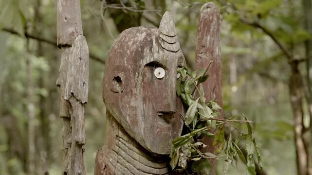 Weathered idols set up in a forest in Ethiopia to mark the grave of a former chief in Konso.	