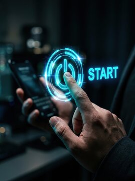 Hand Touching Glowing Blue Digital Start Button with Power Icon for Technology Innovation and Business Launch Concept