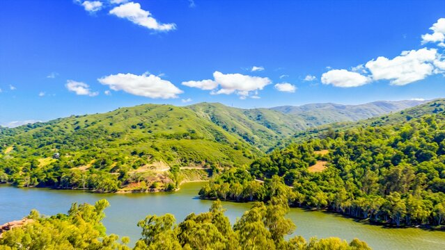 Rolling hills and vibrant green landscape surrounding Gilroy Reservoir near Gilroy Santa Clara County California