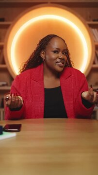 POV of positive Black woman recording blog in library, giving useful tips
