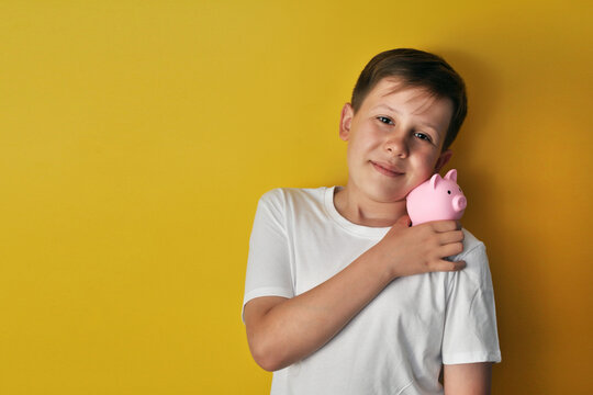 Boy with Piggy Bank on a yellow background