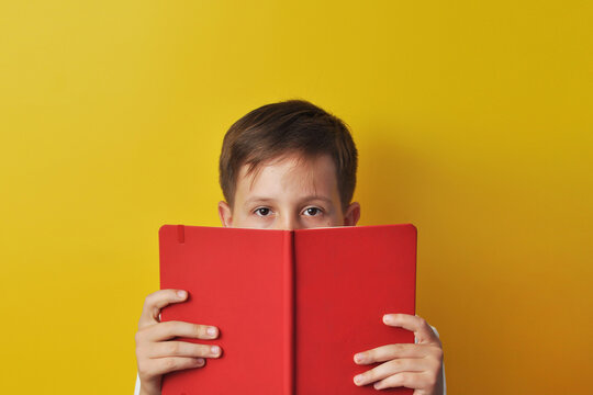 Boy Reading a Large Book
