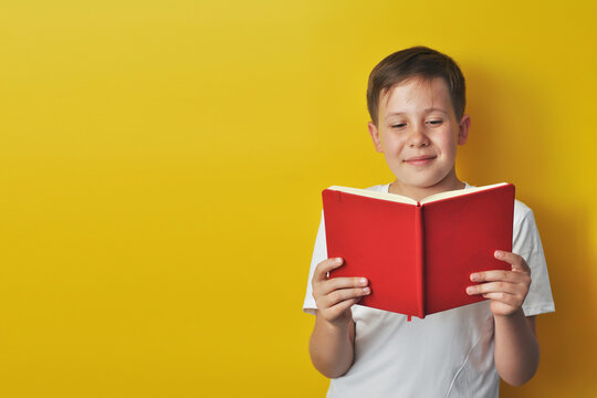 Boy Reading a Red Book
