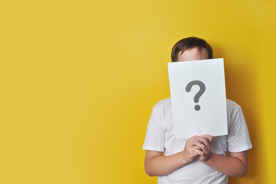Boy Holding a Question Mark Card