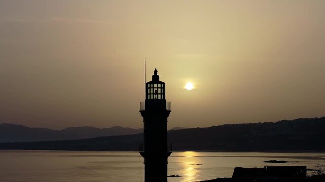  View of Chania with the amazing lighthouse, mosque, venetian shipyards, Crete, Greece.Waves crashing on lighthouse, Beautiful Greece and best scenic places - panorama