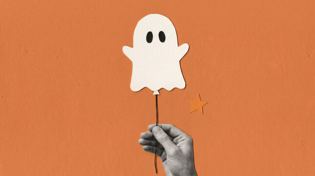 Halloween mixed media collage with grayscale hand holding a white paper ghost and orange star on textured background