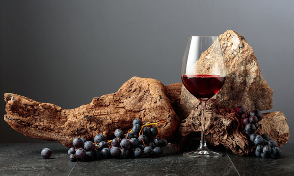 Glass of red wine on a grey background.