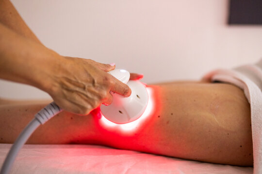 Red light body contouring treatment on female leg