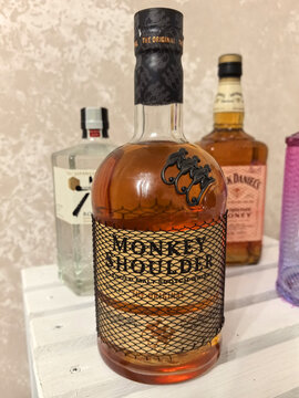 Crafting cocktails with Monkey Shoulder whiskey at a cozy bar setting