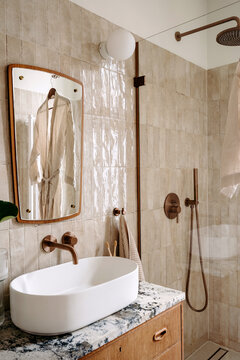 Modern hotel bathroom with white sink and marble countertop