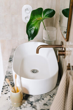 White sink and washbasin in hotel bathroom with modern design and natural elements