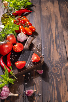 Fresh vegetables and herbs preparing on rustic table