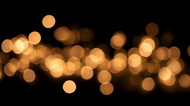 A mesmerizing display of warm golden bokeh lights against a black background, creating a dreamy atmosphere.