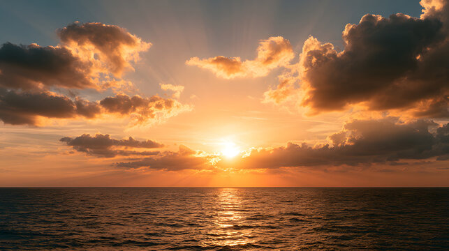 A breathtaking sunset over the ocean, featuring vibrant orange and yellow hues illuminating the sky.