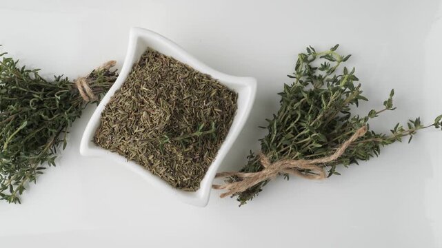 Fresh and dried thyme seasoning isolated on a white background