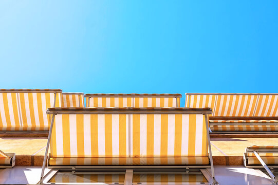 Yellow and white striped awnings protecting from summer sun