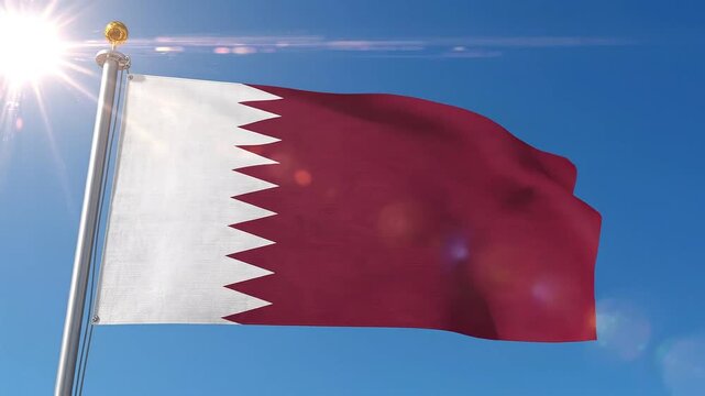 National flag of qatar waving against a clear blue sky with sunlight