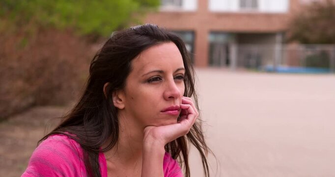 Female sitting outside thinking 4k
