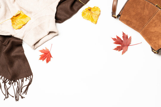 Autumn cloth and accessories at white background with copy space.